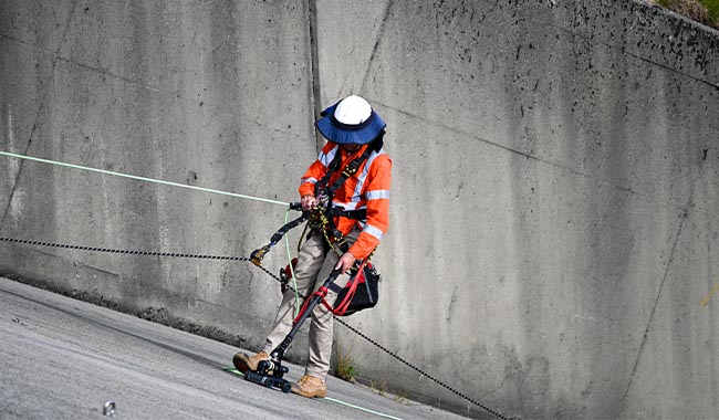Technician using ground penetrating radar equipment on a concrete structure