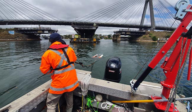 Marine geophysical survey equipment being deployed from a survey boat