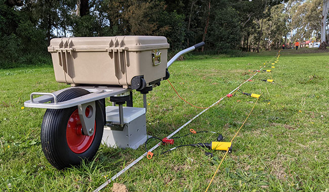 Seismic reflection survey equipment deployed across a field site